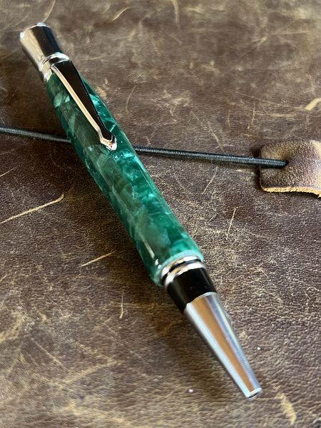 A bright green bodied pen with chrome top finial, clip and nib made in a vintage style.